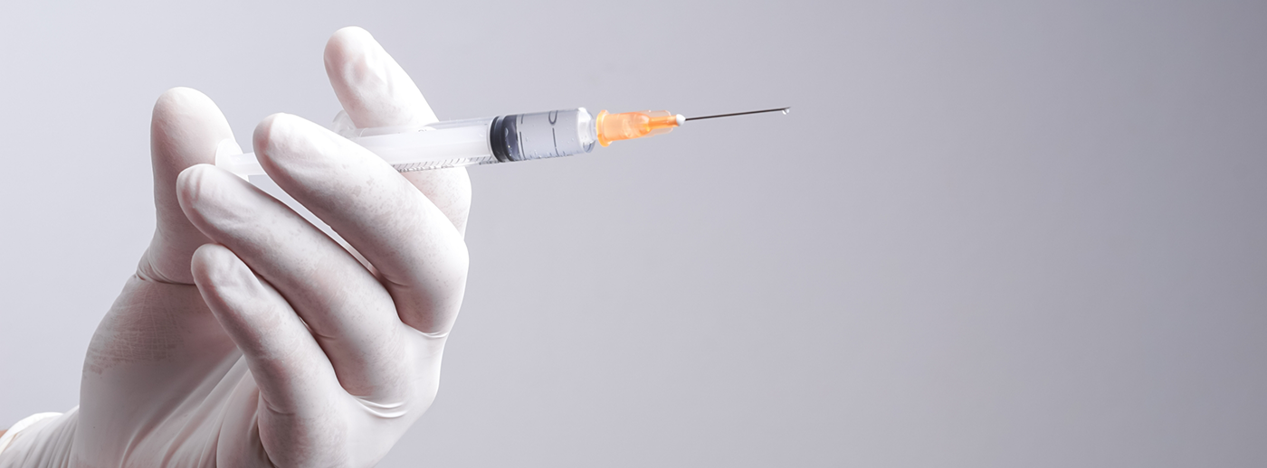 Gloved hand holding syringe for Botox in Sterling Heights