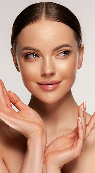 Woman with smooth skin smiling and holding up hands
